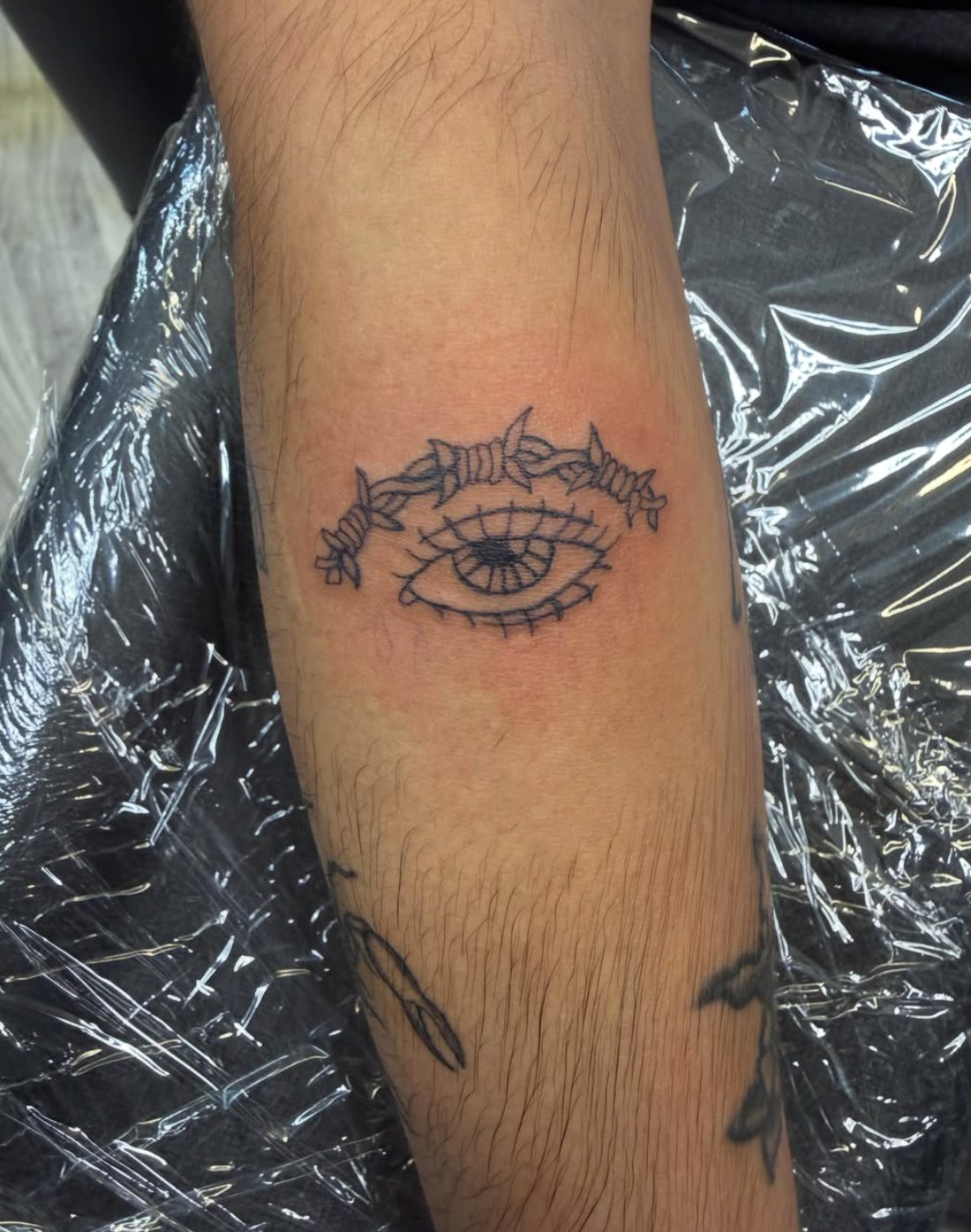 Eye with gothic lettering tattoo