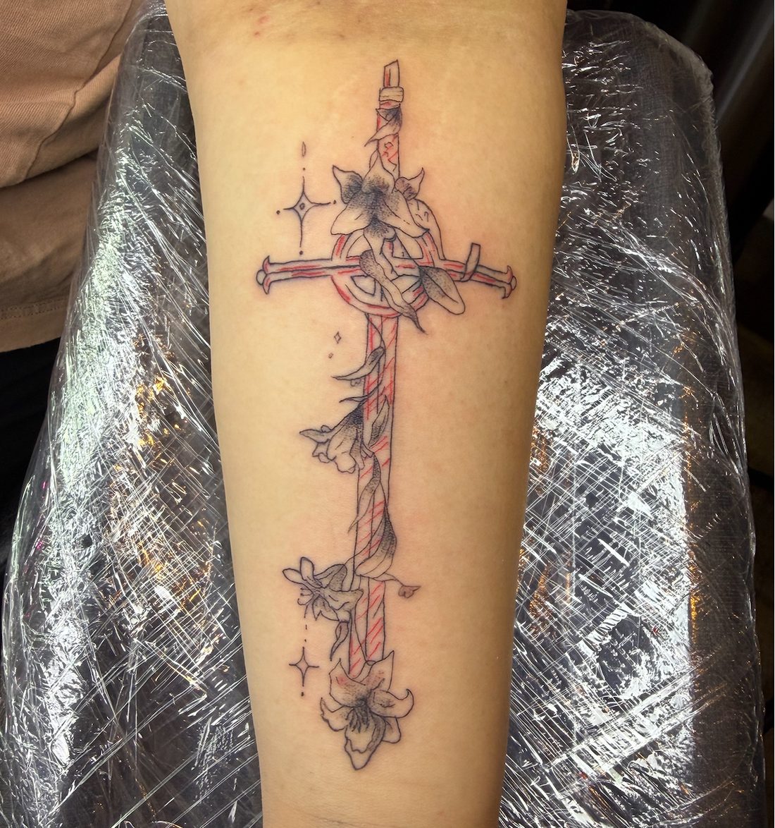 Sword wrapped in lilies, black and grey with red accents