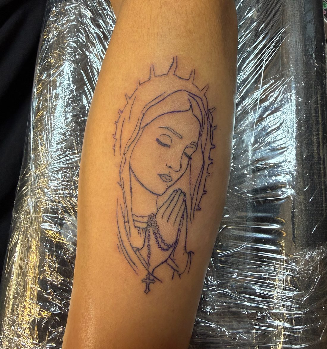 Fine-line Virgin Mary with rosary tattoo